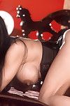 Lovely pornstar Mimi Miyagi shows her big tits springing free from her black, tight, corset