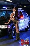 The salacious Asian girl Nautica Thorn is posing half naked against the police car