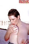Plump pornstar Desirae demonstrating massive saggy boobs outdoors on beach