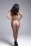 Sexy brunette Alessandra removes her fishnet stockings during hot solo action