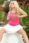 Busty blonde Heather Summers in pink top and white skirt bares it all in the garden