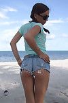 Petite sexy babe stripping on the beach and spreading her sweet cunt