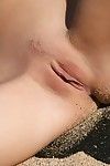 Sexy slim long legged teen Eufrat poses teasing with her nude body at the beach