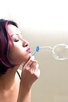 Asian first timer Jade blowing bubbles while exhibiting neatly trimmed twat