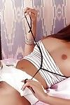Sticky Thai teenager pulls underclothes aside to wank her bushy vagina