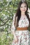 The beautiful Eastern cutie Li Moon is underneath the blossoming tree showing off moist unclothed charms