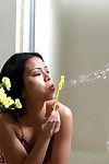 Infant Eastern woman Peggy blows soapy bubbles on her gentile